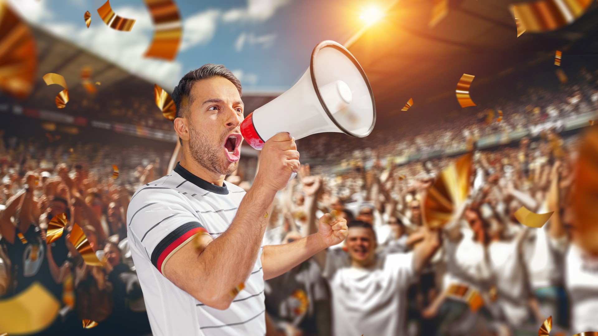 soccer fan with megaphone in hand in soccer stadium celebrating the game.